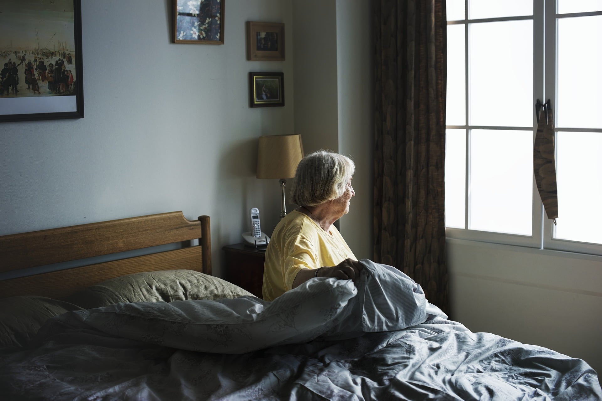 can't pay for nursing home care costs - elderly women getting out of bed