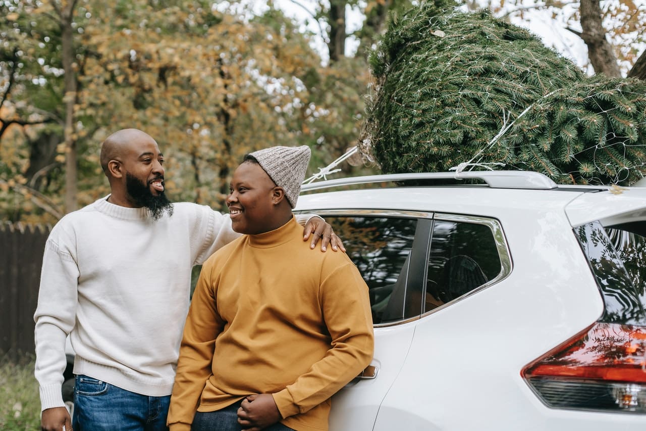 ira for kids -- African American father and teen leaning against a car