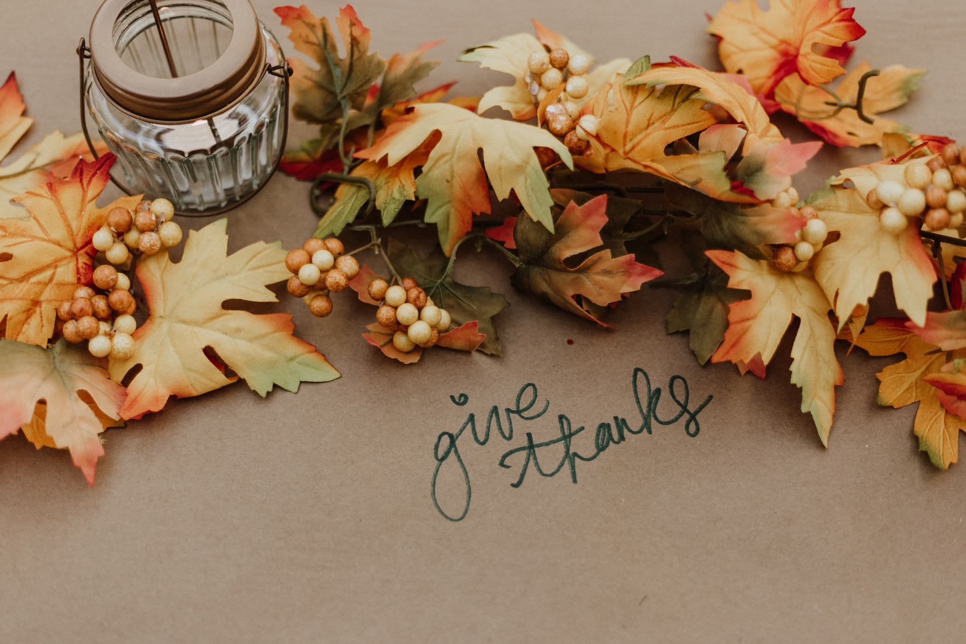 festive table with fall leaves and give thanks quote