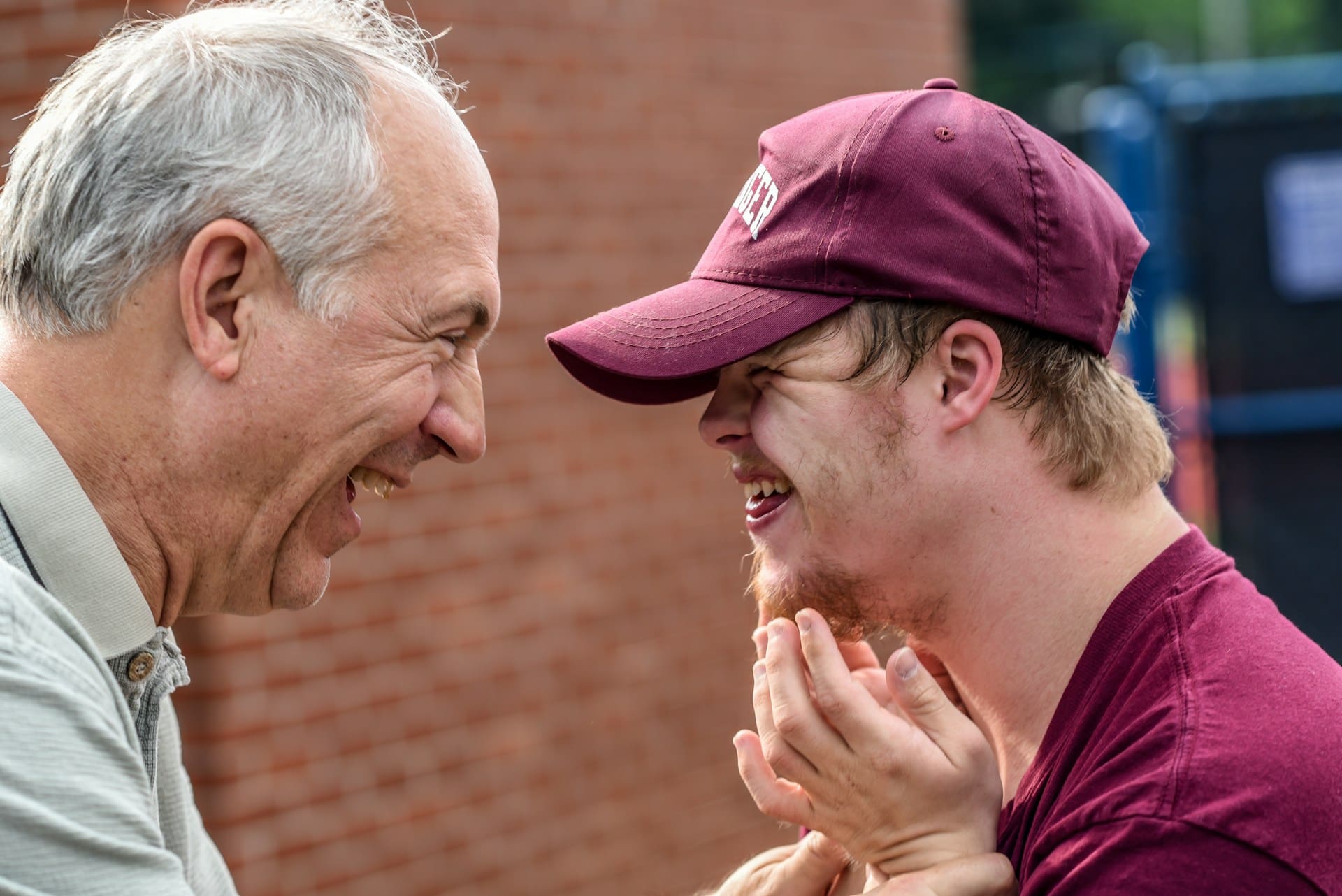 man laughing with son who has special needs